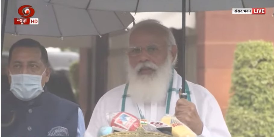 New Delhi, India. 19th July, 2021. Indian Prime Minister, Narendra Modi  holds an umbrella as he speaks to the media on the first day of the Monsoon  Session of Parliament 2021 at